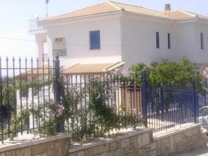 a fence in front of a white house at Villa Rodanthi Sivota in Syvota