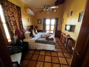 a bedroom with a bed and a ceiling fan at Captain Morgan's Retreat in San Pedro