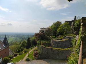 a view of a hill with a stone wall at La halte cycliste in Domfront