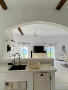 a kitchen with a sink and a counter top at Ocean Garden, 4 units by the ocean in São Vicente