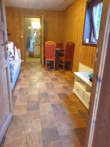 a room with a tiled floor with a table and chairs at Holiday Raustua Cabin in Gol +48 photos