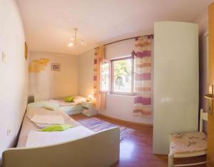 a room with two beds and a window at Apartment s Jukica in Vis