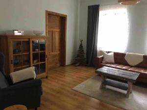 a living room with a couch and a christmas tree at Ferienwohnung in Schmargendorf bei Angermünde in Angermünde