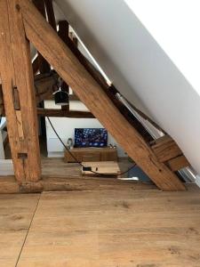 an attic room with wooden beams and a wooden floor at Le Henri IV - Vue Cathédrale, Parking in Rouen