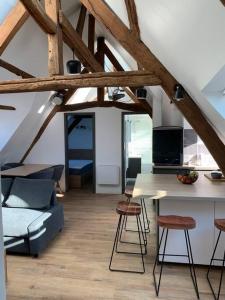 a living room with a couch and a table and chairs at Le Henri IV - Vue Cathédrale, Parking in Rouen