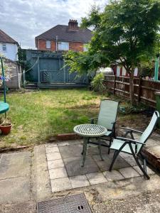 a patio with a table and a chair and a table and a table and chairs at Comfortable and convenient stay 3 bed house in Southampton