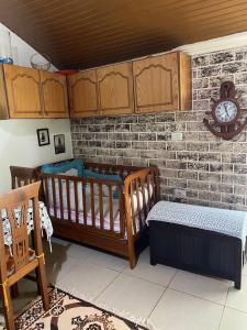 a room with two cribs and a brick wall at Kasaj Villa in Gjirokastër