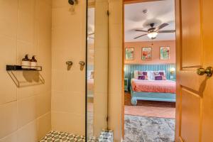 a bedroom with a bed and a glass door leading to a shower at Bocas Paradise Hotel in Bocas del Toro