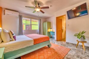 a bedroom with a bed and a ceiling fan at Bocas Paradise Hotel in Bocas del Toro
