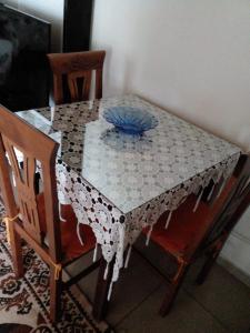 a dining room table with a blue bowl on it at Kasaj Villa in Gjirokastër