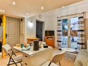 a kitchen and living room with a table and chairs at Vertmarines 165 in Saint-Jean-de-Monts