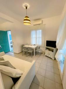 a living room with a table and a tv at Twins Apartments in Fanari