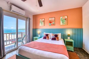a bedroom with a large bed with an ocean view at Bocas Paradise Hotel in Bocas del Toro