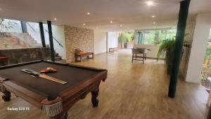 a pool table in the middle of a living room at La Semilla Ecolodge in Cerro Azul
