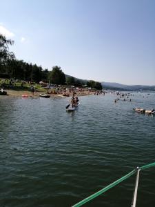 a group of people in the water at a beach at Apartmány Domaša Poľany in Holčíkovce