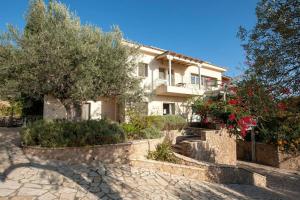 a large house with trees and a stone walkway at Stellar Villa Private Pool-Sea View in Porto Heli