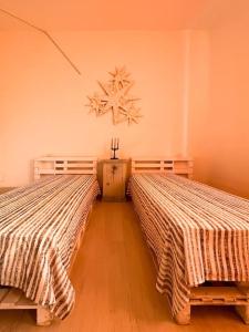 a bedroom with two beds and a snowflake on the wall at Bau!House in Piombino