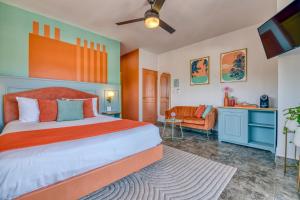 a bedroom with a large bed and a couch at Bocas Paradise Hotel in Bocas del Toro