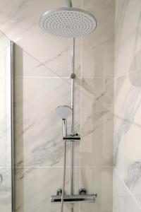 a bathroom with a shower with a light fixture at Buena Vista Ponderosa 517 in Playa Fañabe
