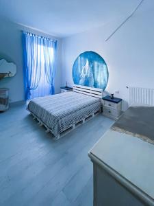 a bedroom with a bed and a blue wall at Bau!House in Piombino
