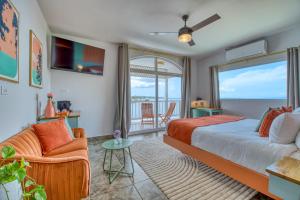 a bedroom with a bed and a view of the ocean at Bocas Paradise Hotel in Bocas Town