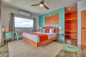 a bedroom with a bed and a large window at Bocas Paradise Hotel in Bocas del Toro