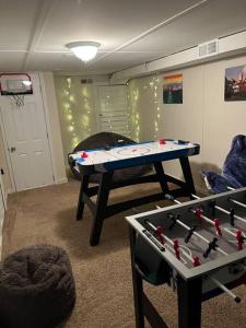 a room with a ping pong table in a room at A Sports Fan Getaway in Baltimore