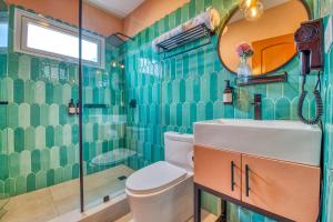 a bathroom with a toilet and a sink and a shower at Bocas Paradise Hotel in Bocas del Toro