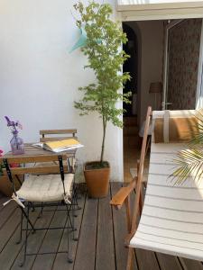 a patio with a table and chairs and a tree at House in the Town Centre in Caminha