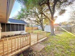 a backyard with a wooden fence and a tree at Comfortable Sleep 08 - Furnished Family Home with Spacious Backyard & Swing in Katy