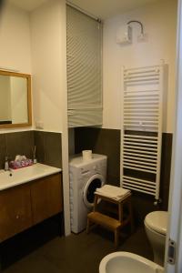 a bathroom with a sink and a washing machine at Casa Mameli - Pesaro Centro/Mare in Pesaro