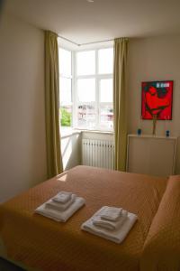 sypialnia z łóżkiem z dwoma ręcznikami w obiekcie Casa Mameli - Pesaro Centro/Mare w mieście Pesaro