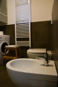 a bathroom with a sink and a toilet at Casa Mameli - Pesaro Centro/Mare in Pesaro