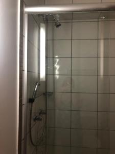 a shower in a bathroom with a glass door at Apartamento Giardino Standard 433 - sem parques in Rio Quente