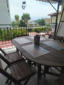 un tavolo in legno e 2 sedie su un patio di Kritharia Guesthouse Volos a Kritharia
