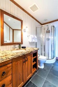 a bathroom with a shower and a sink and a toilet at ALTITUDE 170-2 / PRIVATE Hot Tub on HUGE Terrace in Mont-Tremblant