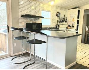 a kitchen with a counter with stools in it at Mi-o My Getaway in Mio