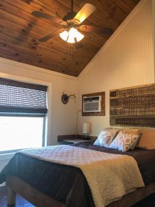 聖馬科斯的住宿－SpecialTies Cottage，一间卧室配有一张带吊扇的床
