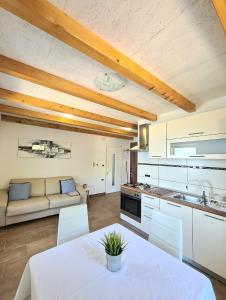 a kitchen and living room with a table and chairs at Apartments Sveti Ivan in Mošćenička Draga +26 photos