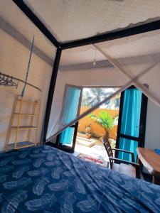 a bedroom with a bed and a large window at Tiger Villa in Midigama East