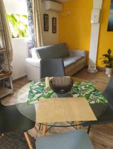 a living room with a couch and a table at Ti’Bou des Îles de Guadeloupe in Le Moule