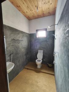 a bathroom with a toilet and a sink at Tiger Villa in Midigama East