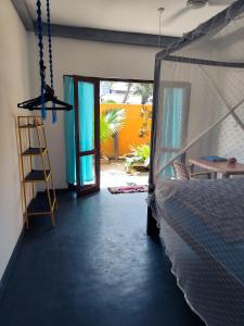 a room with a bed and a door to a patio at Tiger Villa in Midigama East