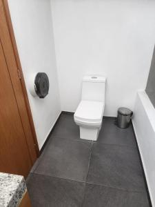 a bathroom with a toilet and a trash can at MOTEL PREMIER in Guadalajara