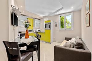 a kitchen and living room with a table and a couch at Apartments Saxo in Kotor