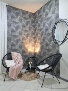 Zimmer mit 2 Stühlen und einer Wand in der Unterkunft OnlyStudio in Zadar