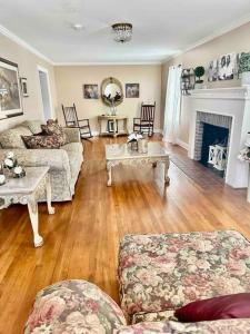 a living room with two couches and a fireplace at The Hooper House in Grenada