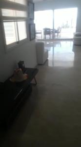 un soggiorno con divano e tavolo di Bel appartement à sania plage vue sur mer a M'diq