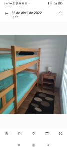 two bunk beds in a room with a table at Cabañas buchupureo in Buchupureo
