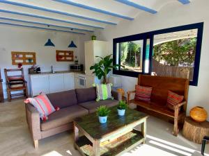 a living room with a couch and a table at Villa Buda Begur in Begur